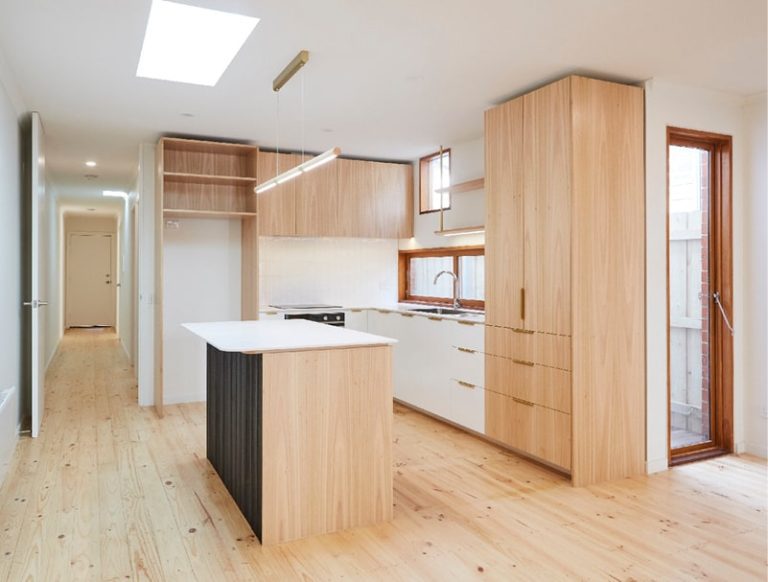 A kitchen featuring wooden cabinets and a skylight, showcasing a bright and inviting renovation space.